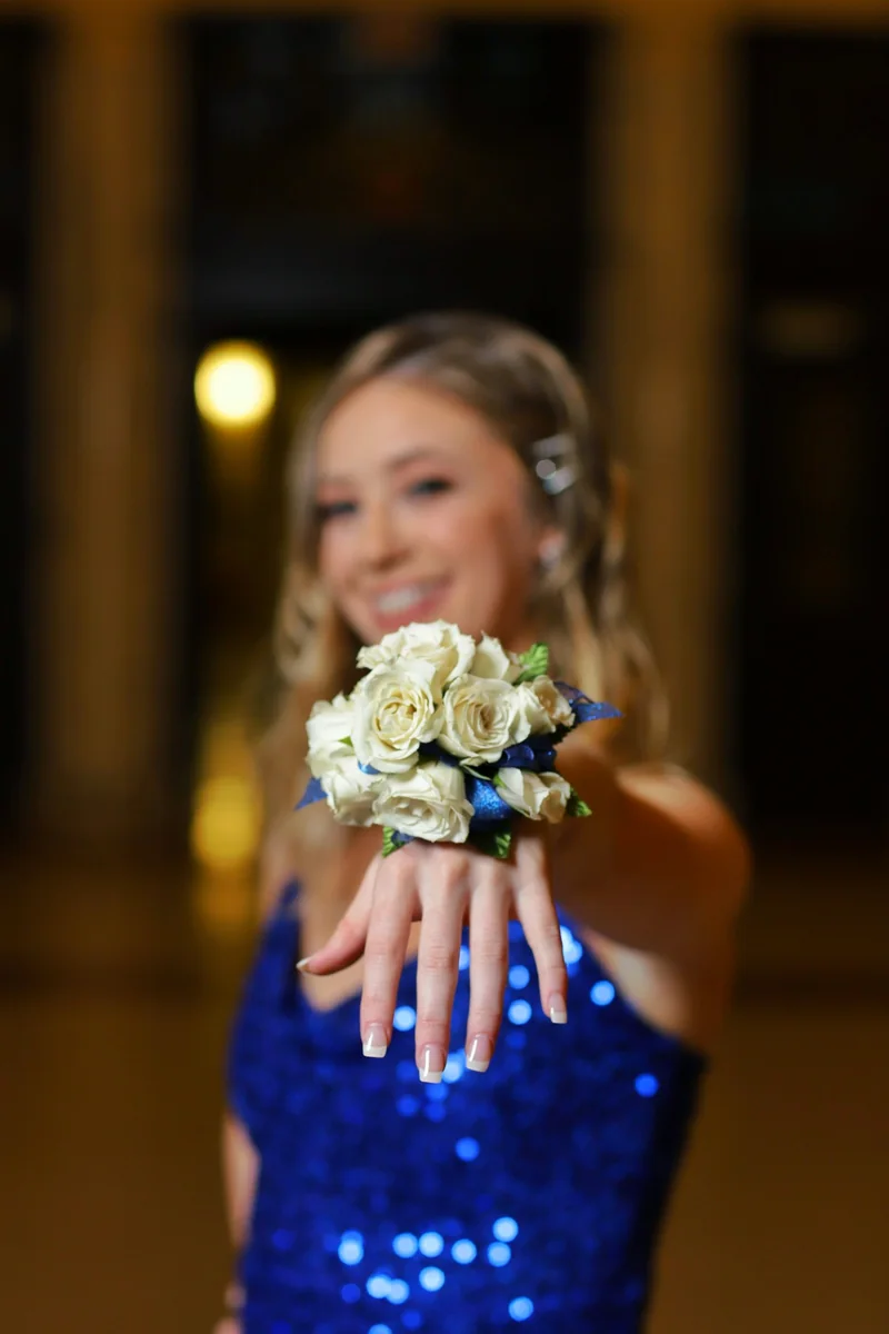 Blue-and-white corsage above a blue formal dress
