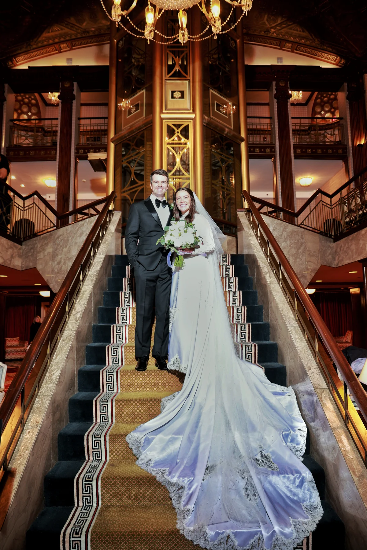 Newlyweds standing together inside their reception venue
