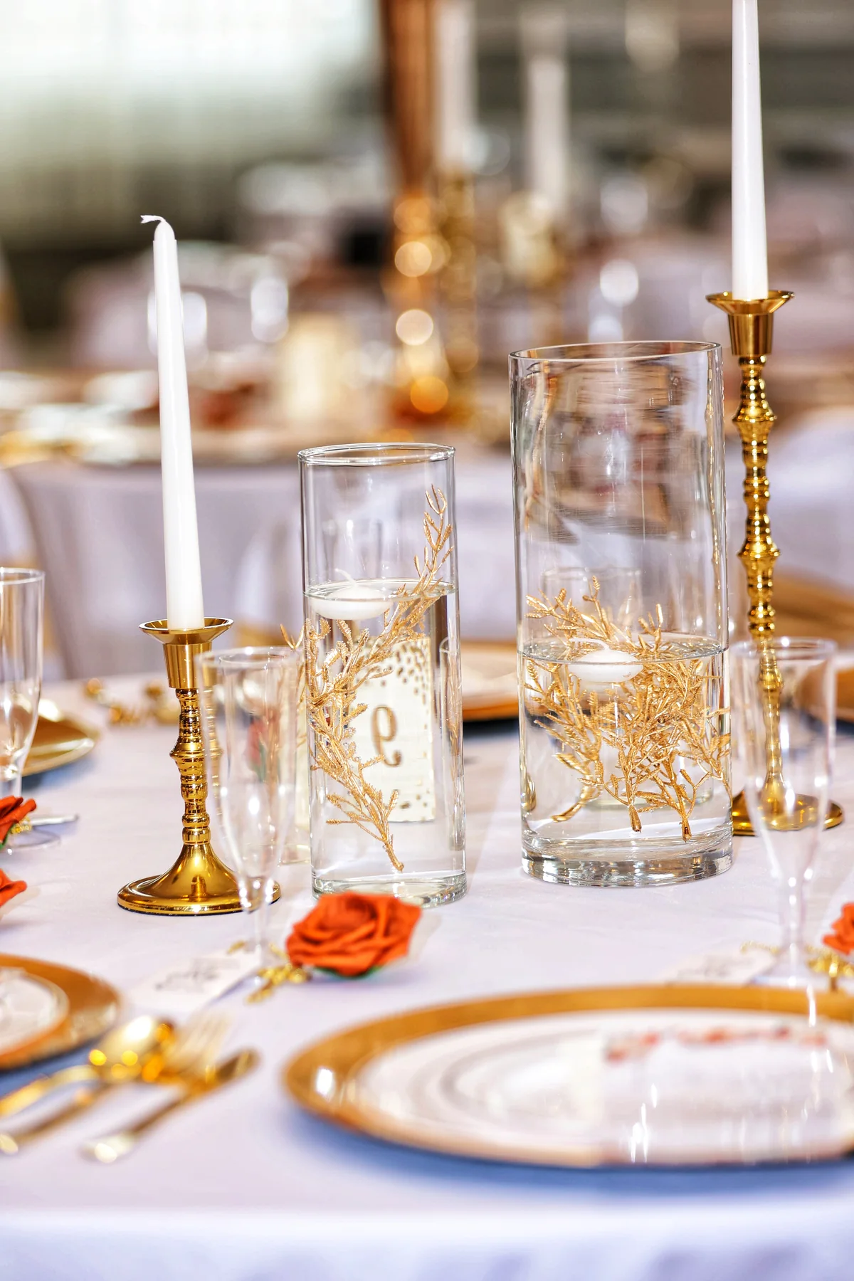 Warm candlelight and table details prepared for a wedding reception